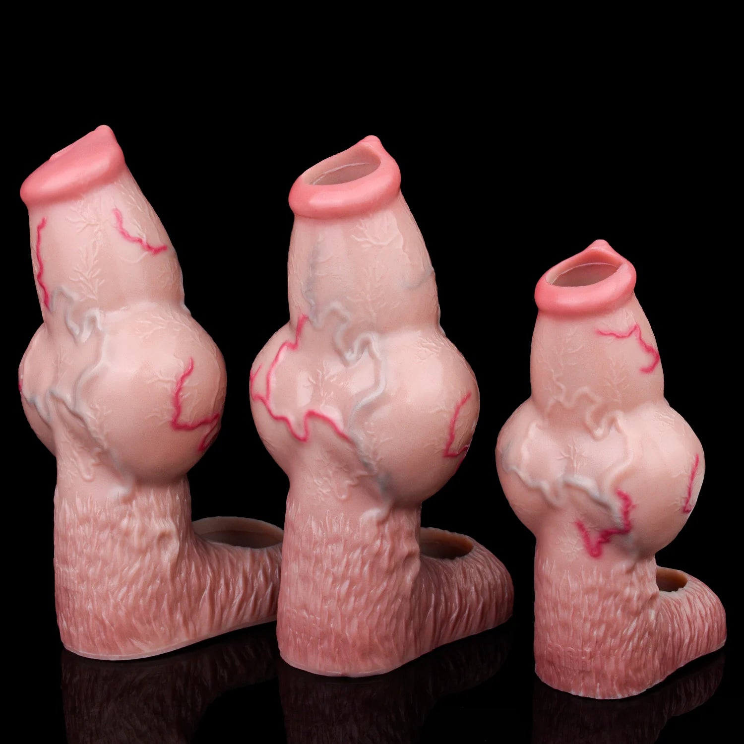 Set of three pink knotted dog cock sleeves in different sizes, open sheath tips.
