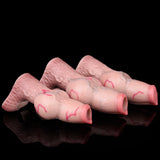 Three pink knotted dog cock sleeves laid side by side, open sheath tips visible.