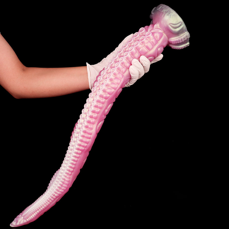 Pink tentacle dildo with ridged shaft and curled tip, shown held by hand