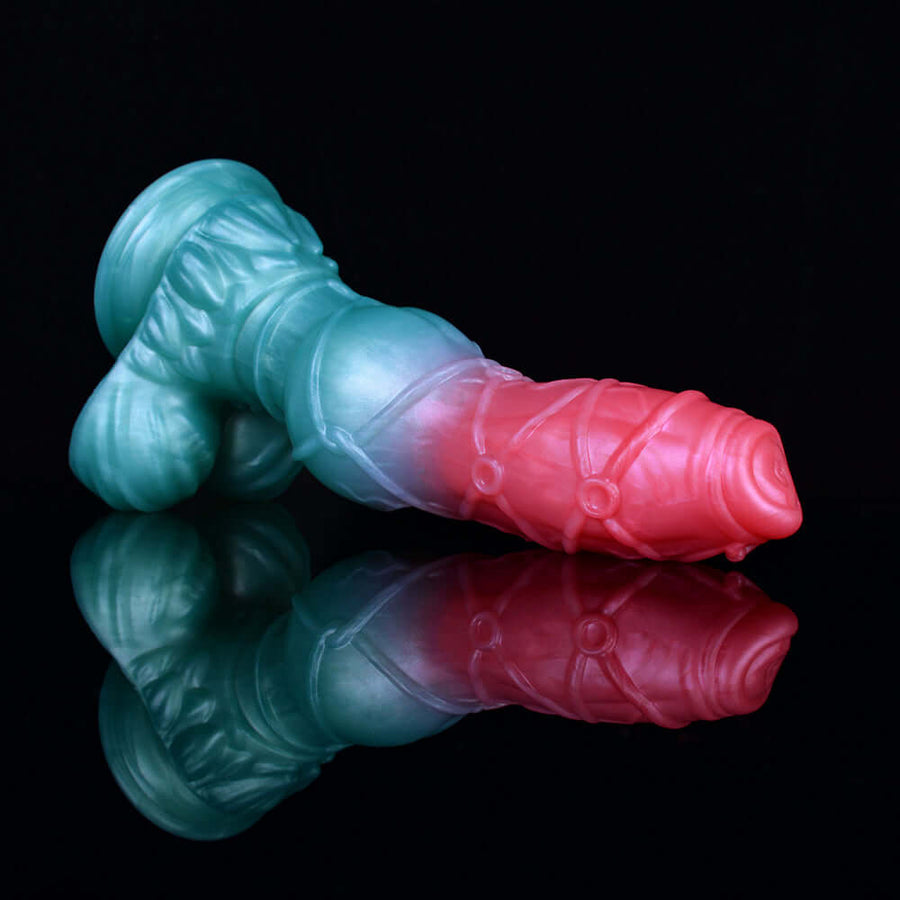 Knotted alien dog-themed sex toy, teal-blue body with pink tip, side view