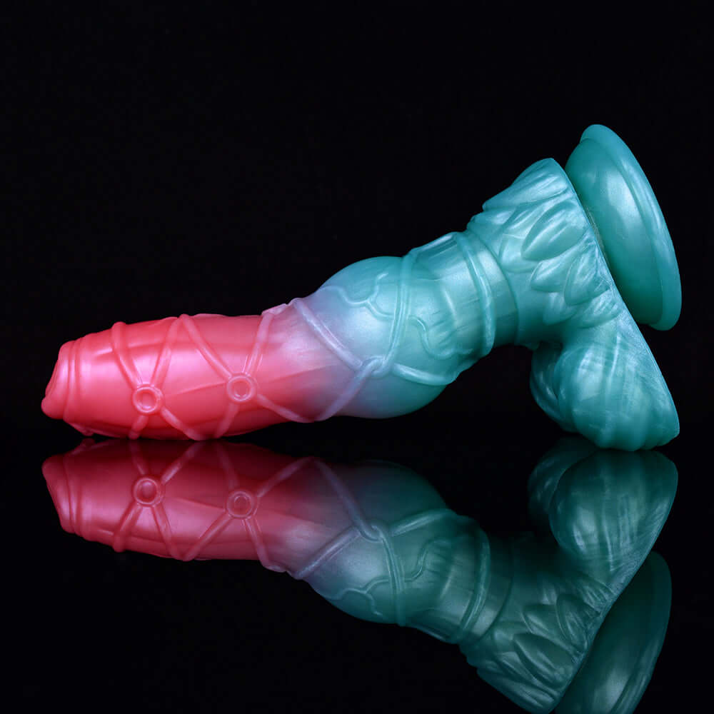 Blue and pink alien dildo close-up with flared ring base and ridged midsection.