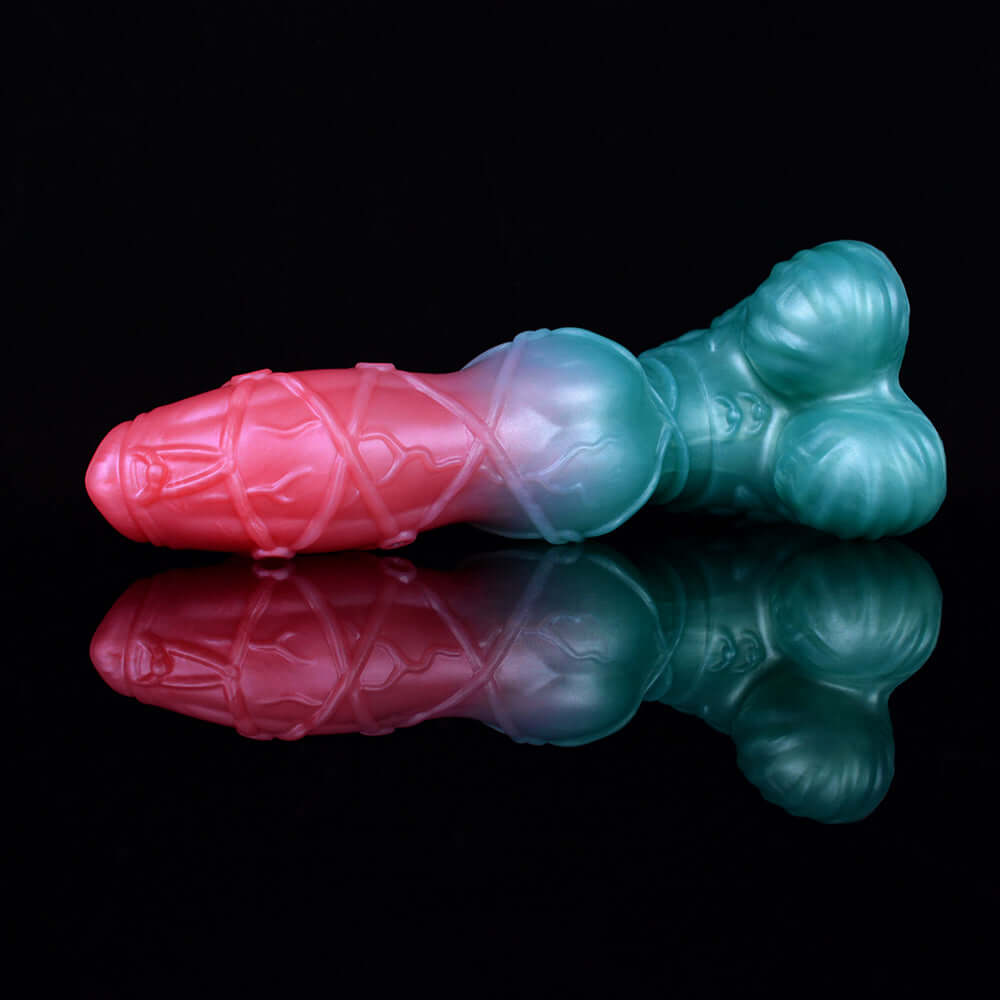 Pink and light-blue alien dildo with detailed ridges and bulbous knot base.