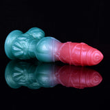 Side view of pink-tipped and blue-based knotted alien dildo with mirrored reflections.