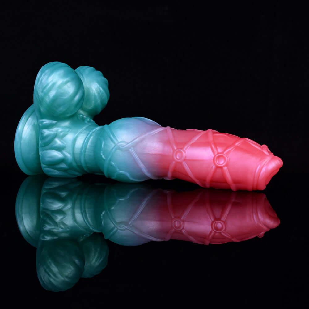 Blue and pink knotted alien dildo with rounded base and pointed tip, reflective finish.