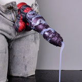 Purple-and-silver alien dildo with red base, clear tube dispensing from tip