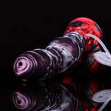 Close-up of purple-and-silver alien dildo with red base and clear suction tube