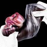 Rabbit-shaped sex toy being held; pink face and dark gray glossy body detail