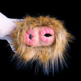 Close-up of dual openings inside brown-gold fur hood with gloved hand