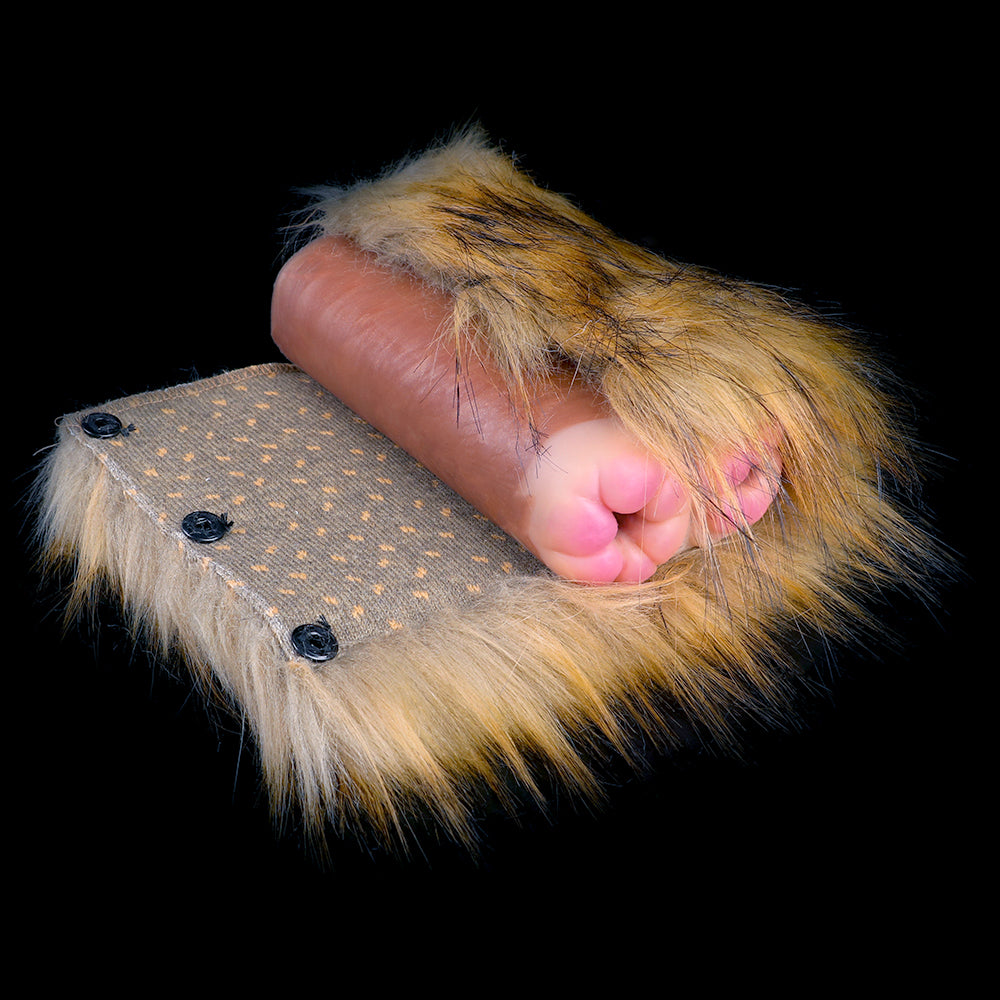 Partly opened brown-gold faux-fur dual-hole stroker lying on a plush base
