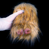 Gloved hands lifting brown-gold faux fur to reveal the dual openings