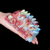 Octopus vibrating grinder toy in hand, multicolor textured ridges