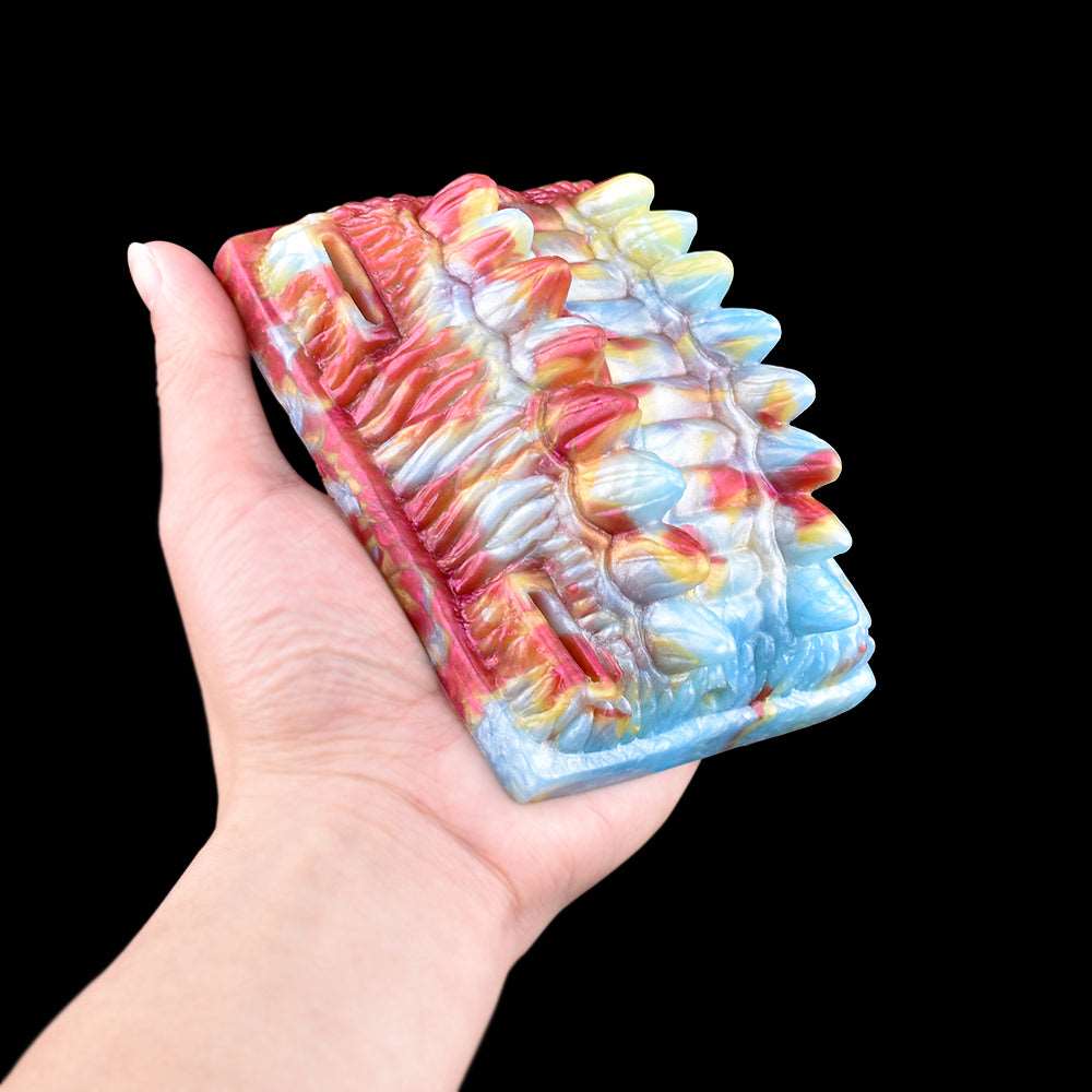 Octopus vibrating grinder toy held in hand, close-up multicolor spiky texture