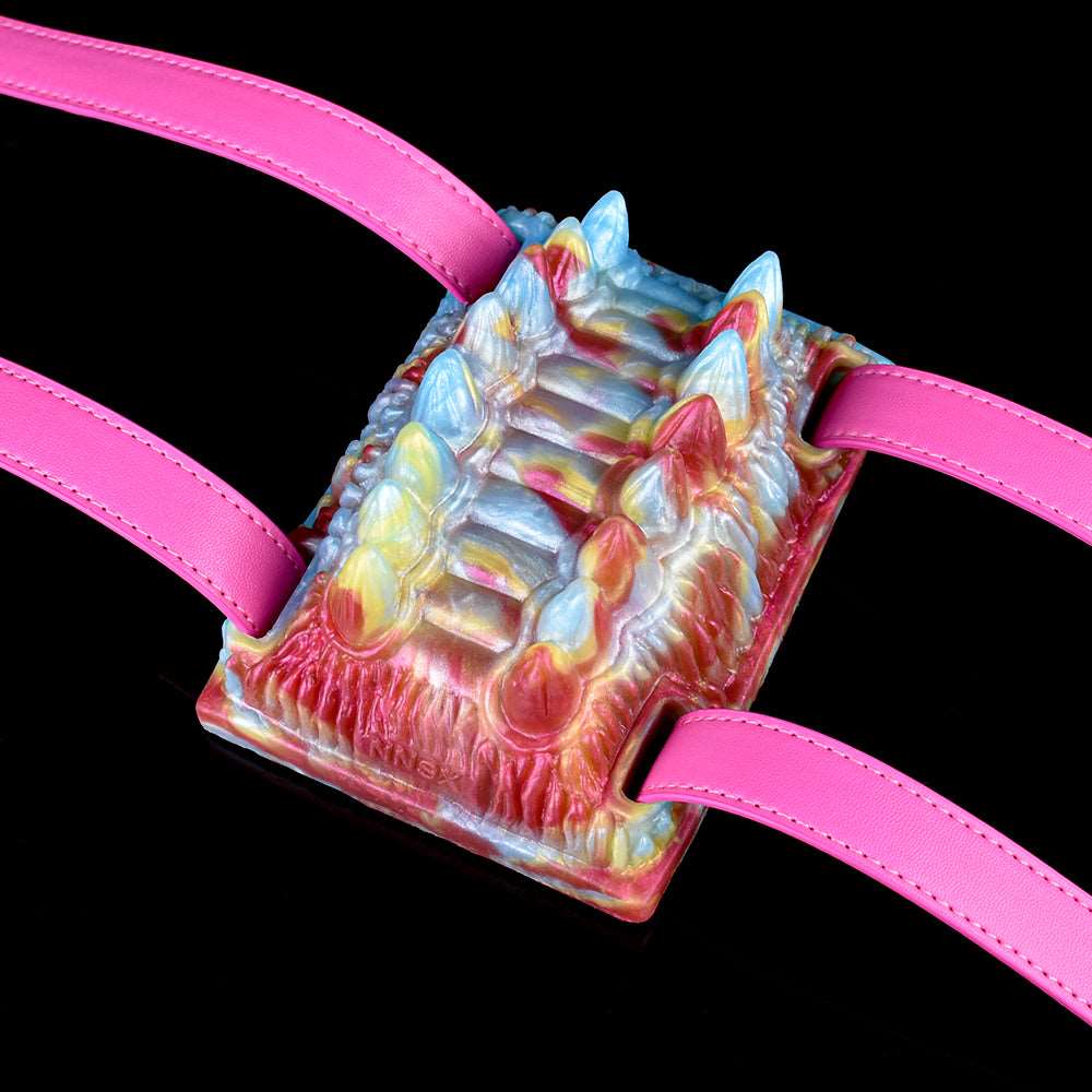 Octopus vibrating grinder close-up with pink straps, multicolor tentacle texture