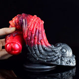 Close-up dragon dildo curve: red ribbed shaft and dark metallic foot with suction cup