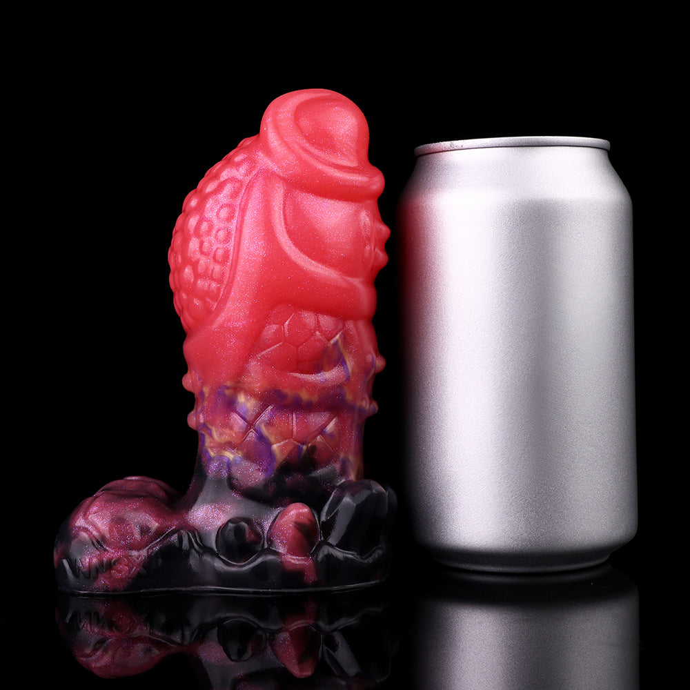 Dragon knot butt plug beside a can, glossy pink and purple body with black base
