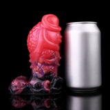 Dragon knot butt plug beside a can, glossy pink and purple body with black base