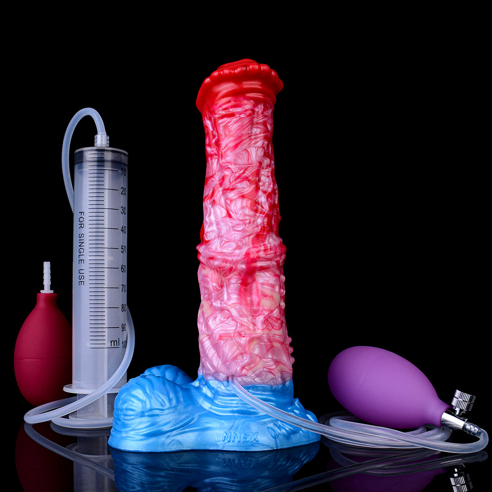 Expanding dildo upright with blue base, red tip, connected tubing and measuring syringe