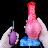 Pink expanding dildo with red tip, rounded bulb head, blue base, hands in gloves