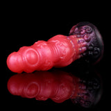 Alien butt plug side profile; glossy red ribbed shaft with textured dark purple rim.