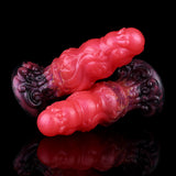 Alien butt plug mirrored angle; glossy red ribbed body and dark purple base texture.