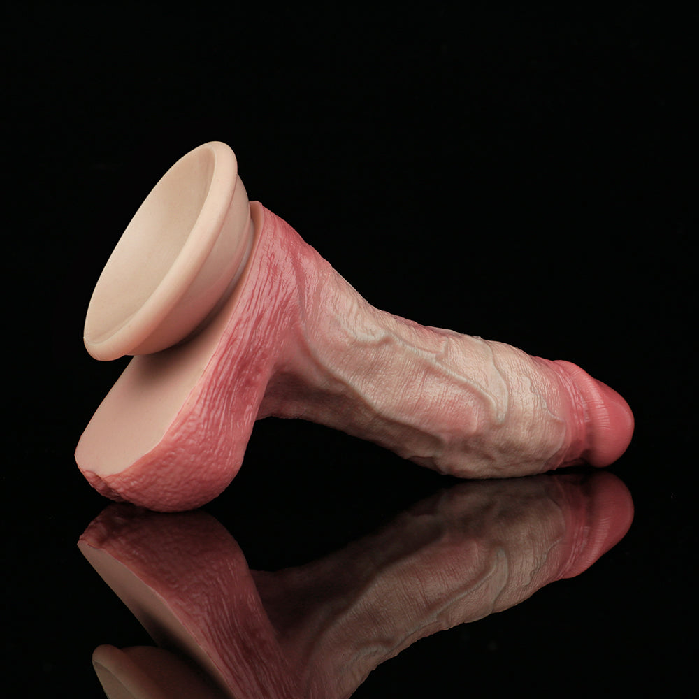 Realistic silicone dildo angle view, pink textured shaft with flared base