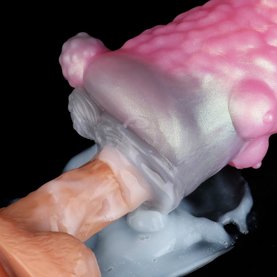 Close-up of pink and gray adult novelty toy with textured outer surface and inner insert