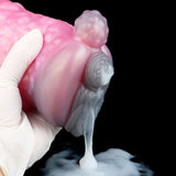 Pink animal-themed sex toy underside held by white glove, gray inner part and drip shape