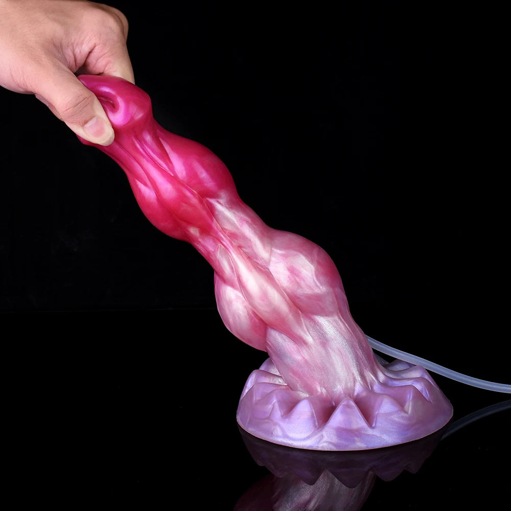 Minotaur squirting dildo held upright, pink-purple, with clear tube