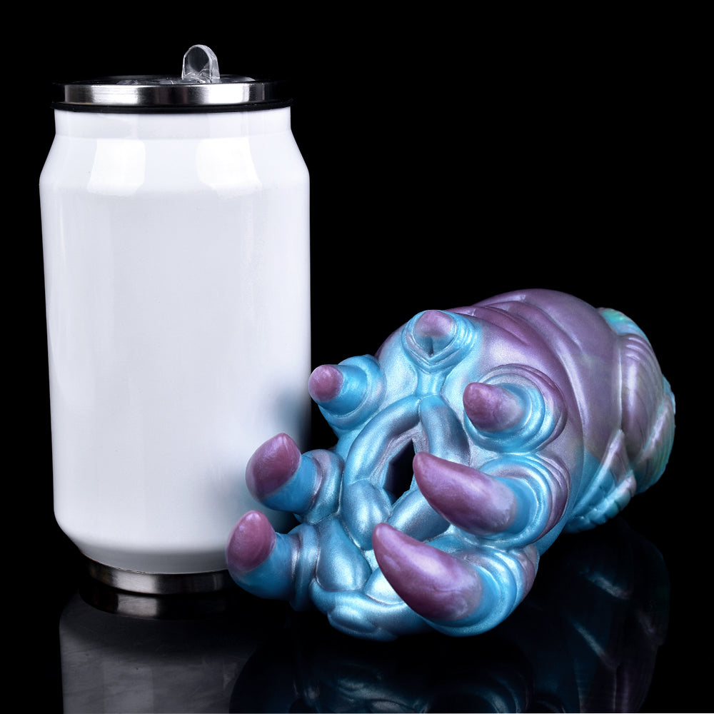 Alien claw stroker with white storage cup and metal top, angled side view