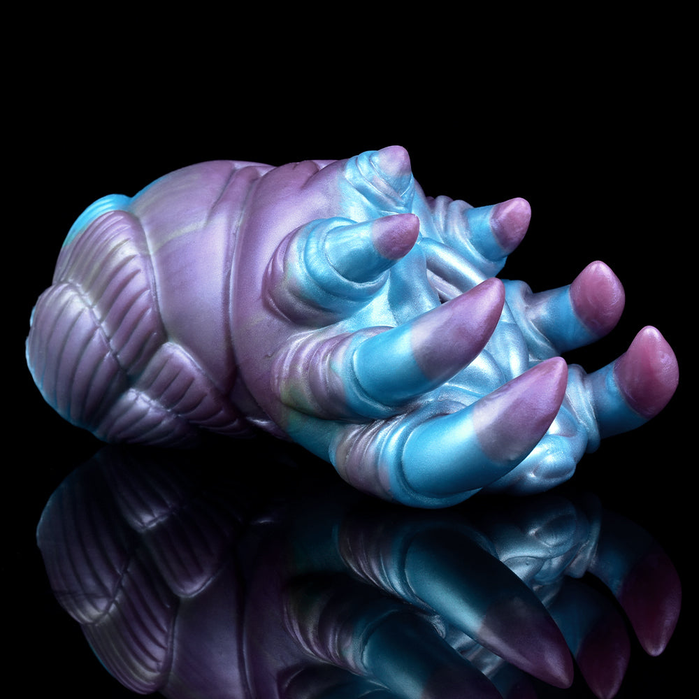 Alien claw stroker angled view: ribbed base and multiple purple-tipped claws