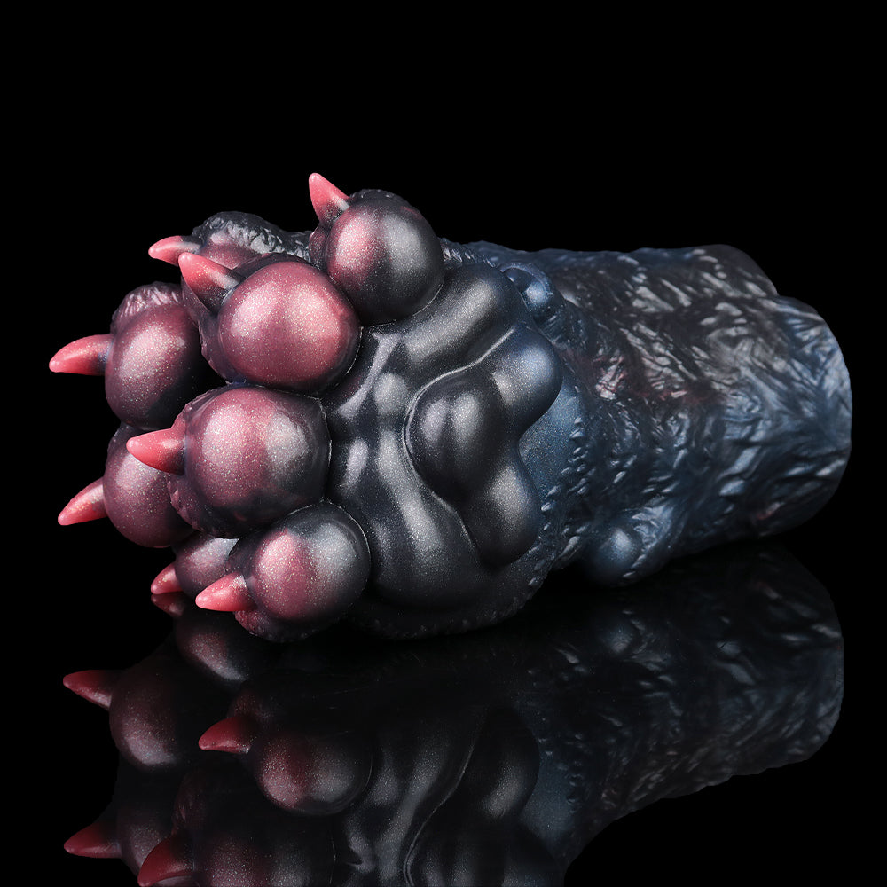 Monster paw pocket pussy sleeve, close-up with glossy dark purple-blue skin and pink pads