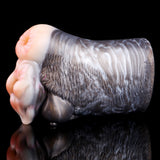 Side view of goat masturbator with dark fur sleeve and light molded handles