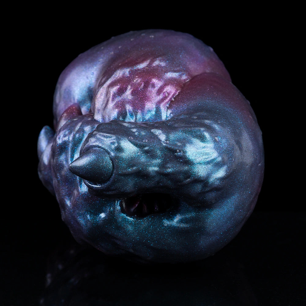 Blue-purple metallic alien head-shaped masturbator with pointed snout and visible opening.