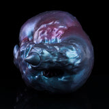 Blue-purple metallic alien head-shaped masturbator with pointed snout and visible opening.