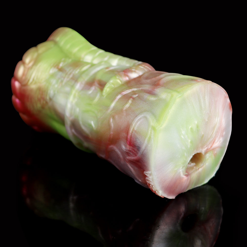 Two-hole dragon fleshlight end view, pale green body with pink accents