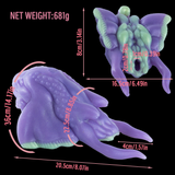Purple and green alien figurine with curled tail and webbed legs, shown with measurements
