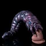 Metallic purple creature head-and-hand figure with blue eye and curled fingers