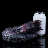 Purple alien creature toy curled beside a white canister, glossy textured surface