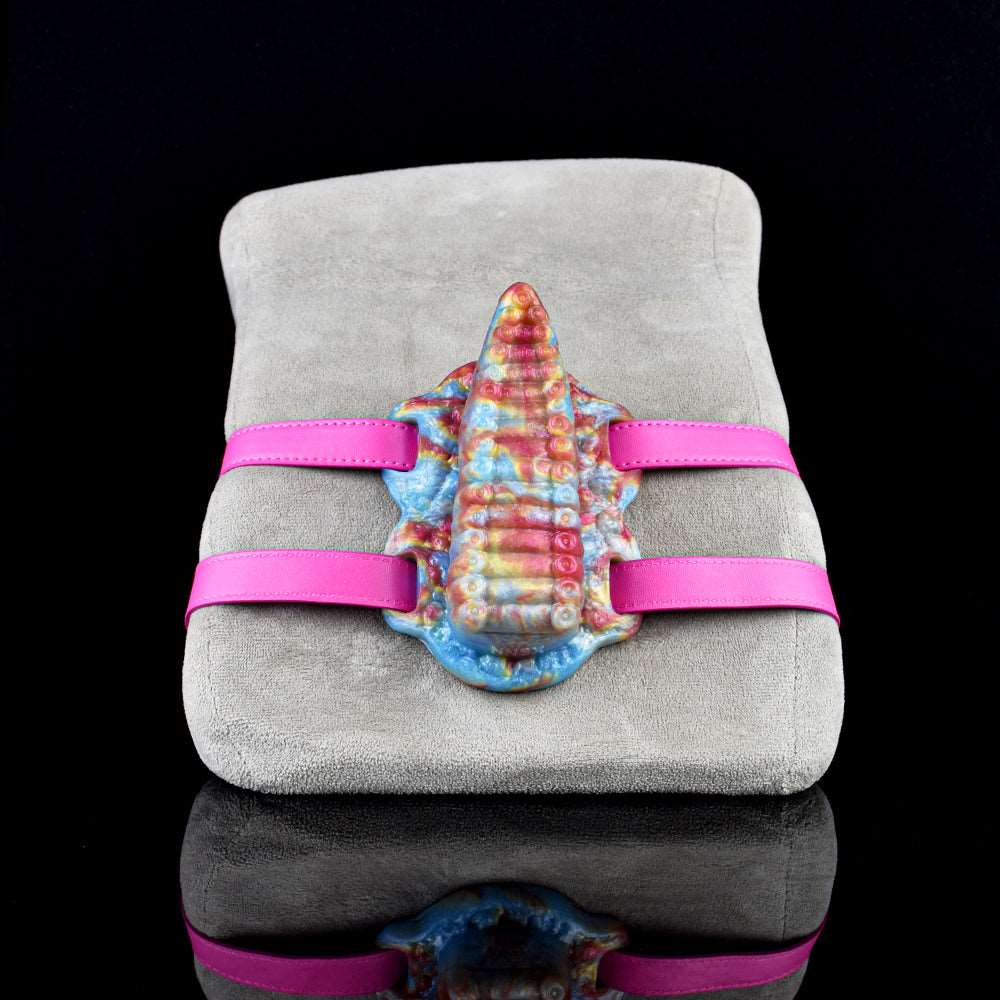 Tentacle-style toy with pink straps on gray seat; rainbow textured body