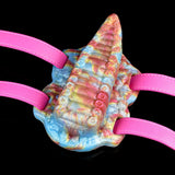 Tentacle-style toy close-up with pink straps and rainbow spiral ridges