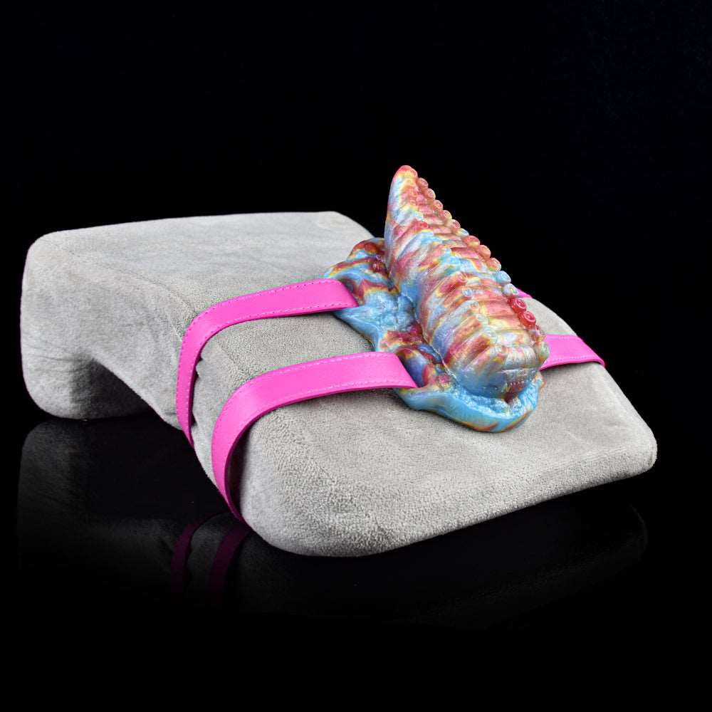Tentacle toy on gray seat with pink straps; rainbow ridged body