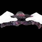 Octopus tentacle toy held by white-gloved hands, purple body and tentacles