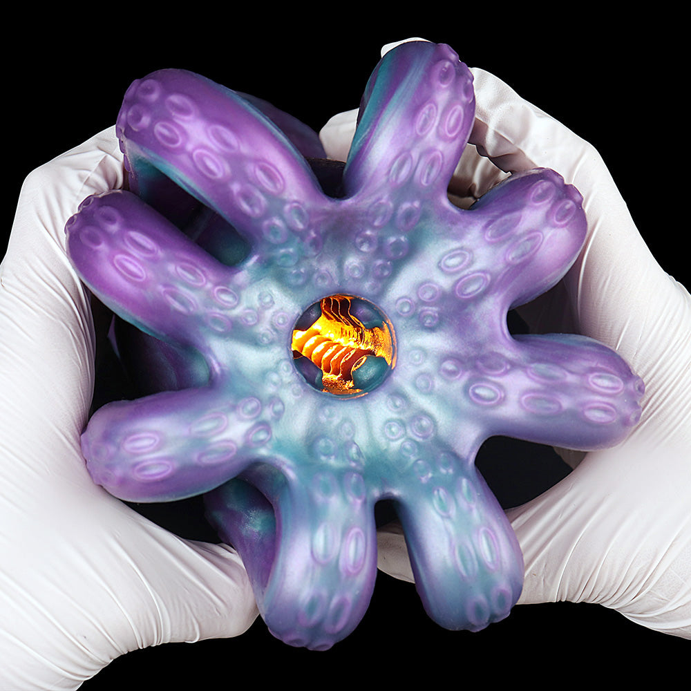 Octopus tentacle masturbator held in white gloves, showing orange inner opening