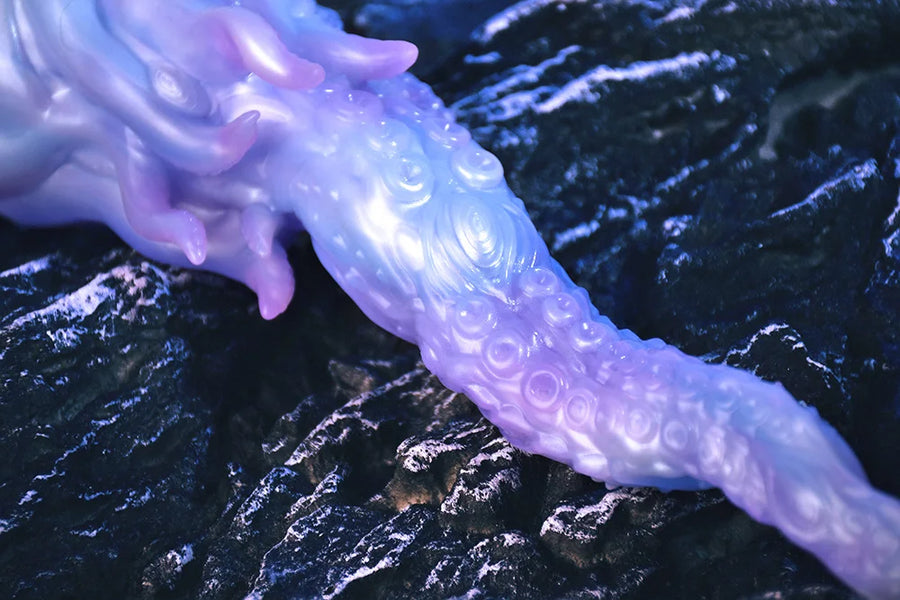 Purple tentacle-shaped fantasy plug dildo with ribbed texture, close-up view