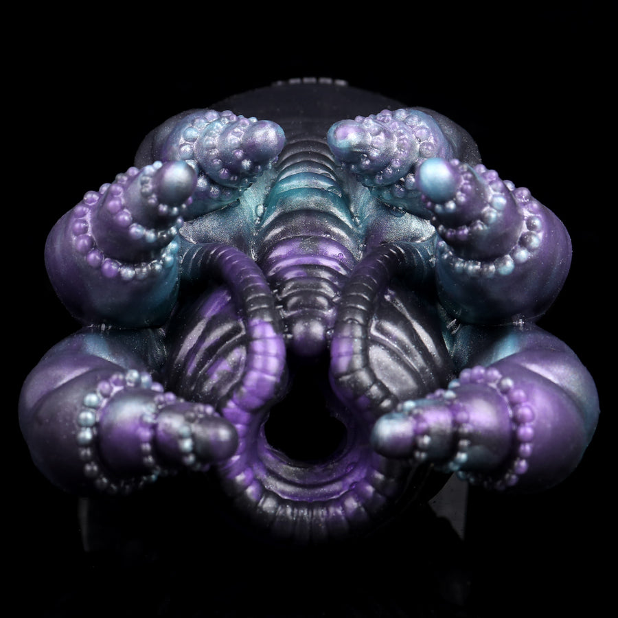 Fantasy octopus-shaped stroker head with glowing teal core and purple tentacles.