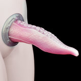 Pink translucent tentacle dildo with ribbed texture and rounded suction bumps; side view