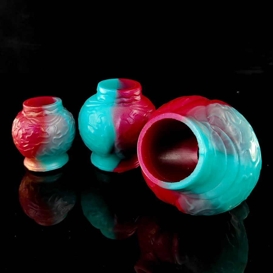 Colorful textured silicone cock ring with knot-like ridges, turquoise and pink.