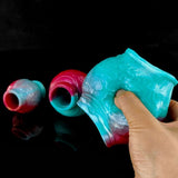 Close-up of dog knot cock rings with open center, pink-and-teal gradient