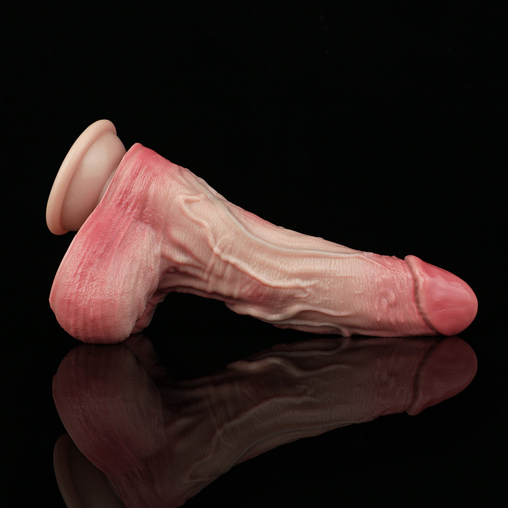 Pink realistic dildo with veining along shaft and rounded flared base.