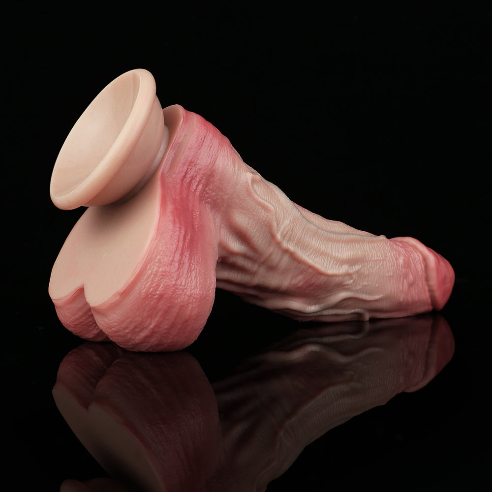 Pink realistic dildo with veining detail and wide flared base, angled view.